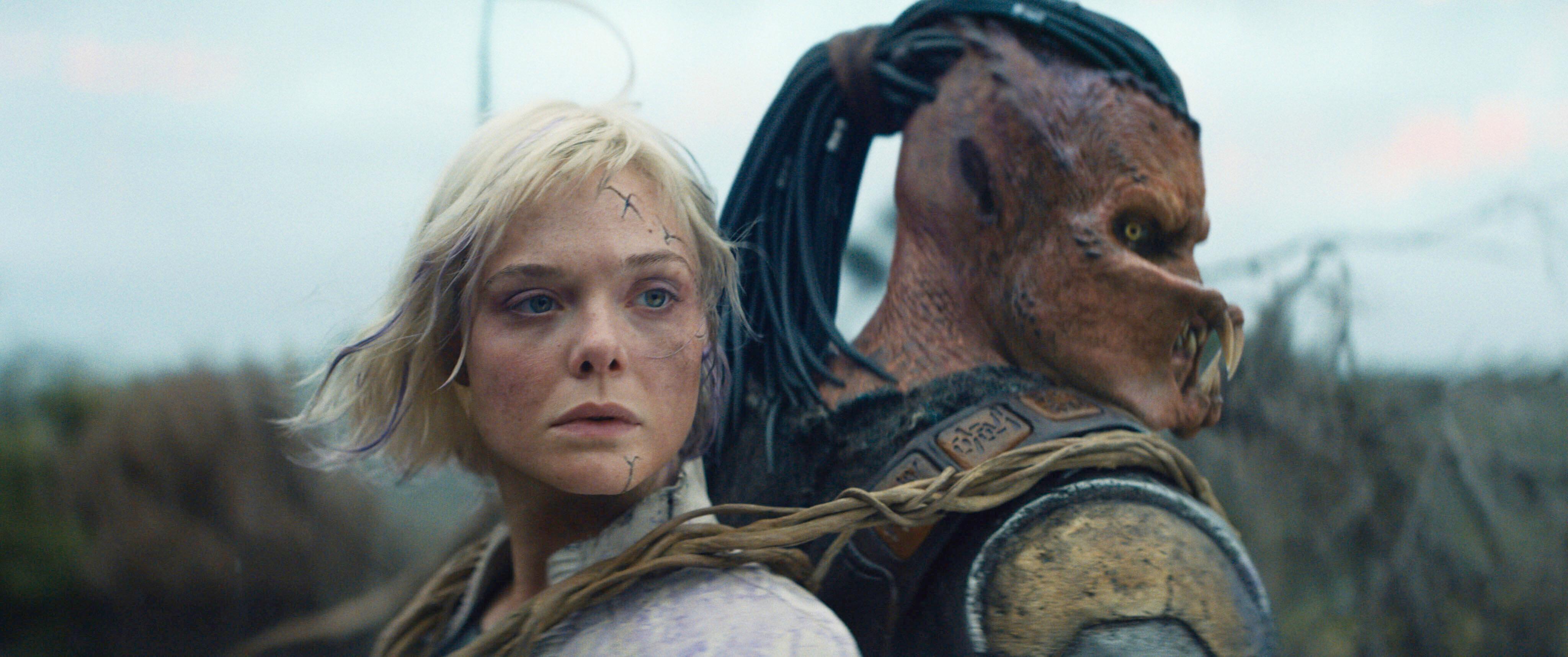 This image released by 20th Century Studios shows Thia, portrayed by Elle Fanning, left, and Dek, portrayed by Dimitrius Schuster-Koloamatangi, in a scene from “Predator: Badlands.” (20th Century Studios/Disney via AP)
