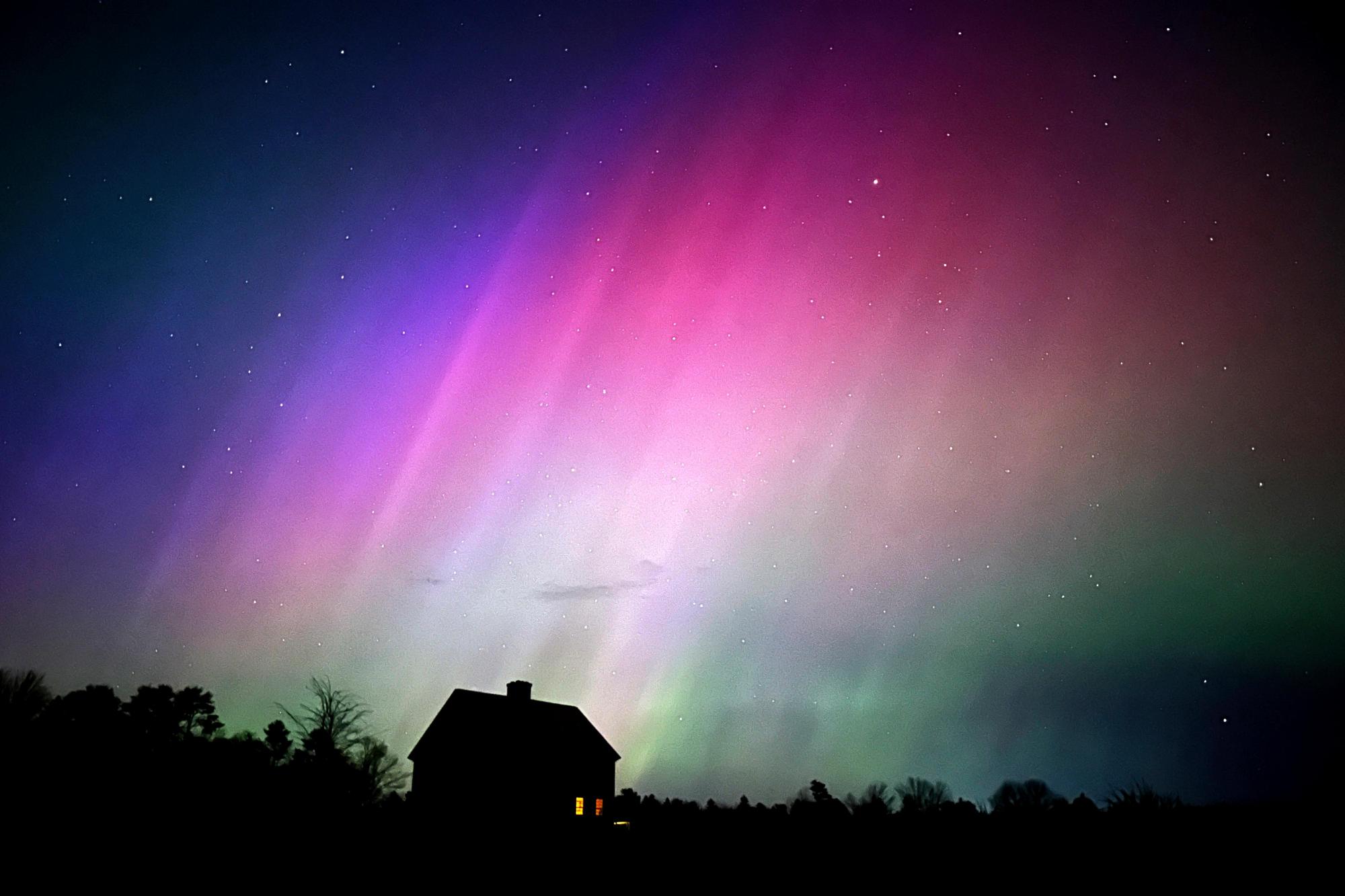 FILE – The northern lights flare in the sky over a farmhouse, May 10, 2024, in Brunswick, Maine. (AP Photo/Robert F. Bukaty, File)
